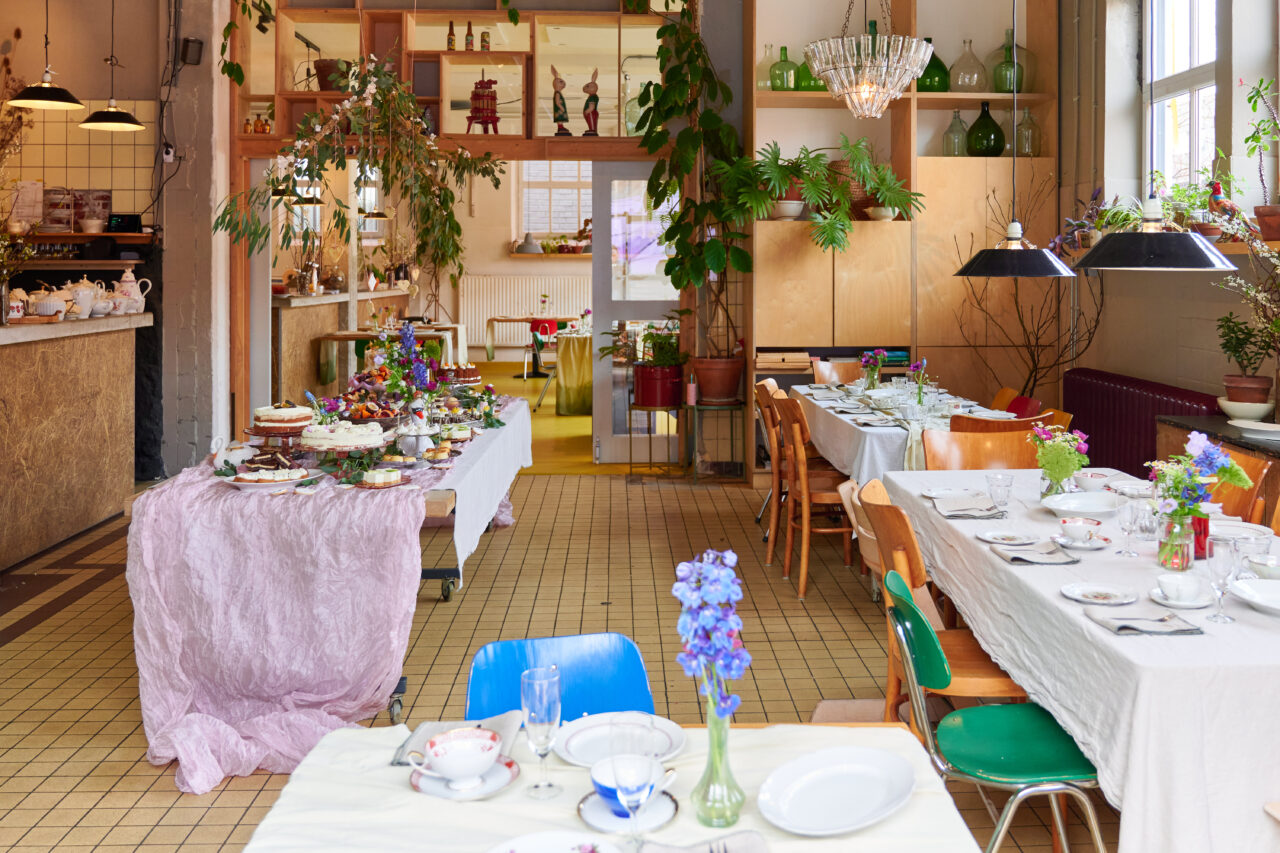 Gedekte tafels bij Bie de Buuf met bloemen en vintage servies
